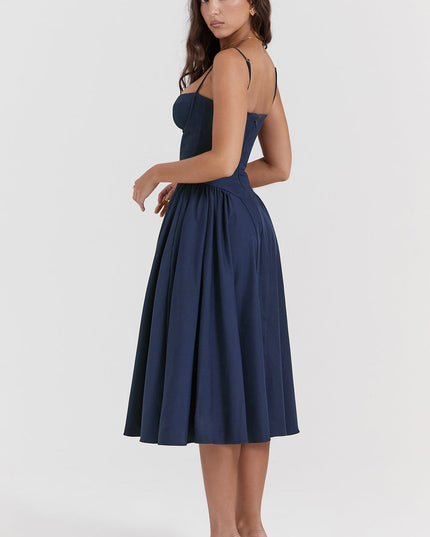 Navy corset midi dress side view showing fitted waist, thin straps, and voluminous midi skirt