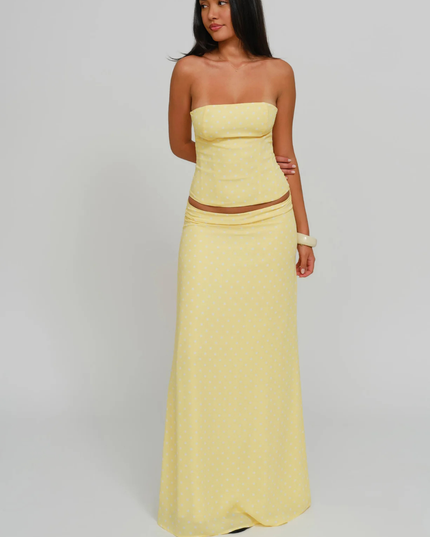 Yellow polka dot strapless corset maxi dress three-quarter view with fitted bodice and long skirt