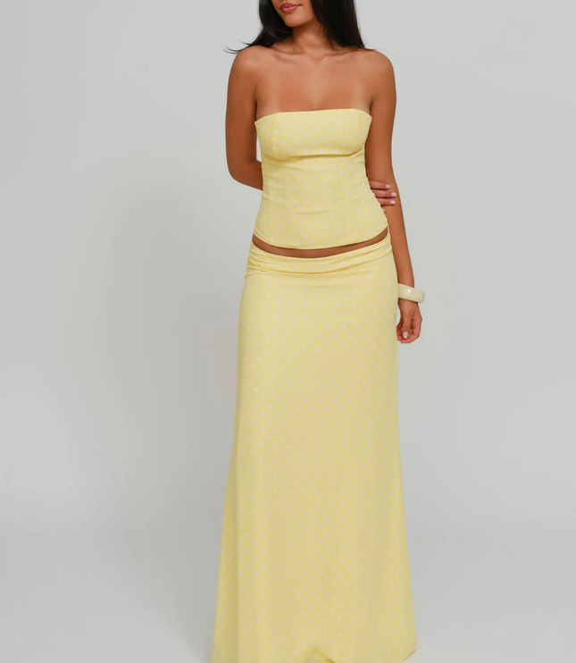 Yellow polka dot strapless corset maxi dress three-quarter view with fitted bodice and long skirt