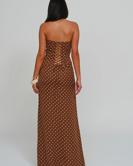 Back view brown polka dot corset maxi dress featuring lace-up back detail and floor-length skirt