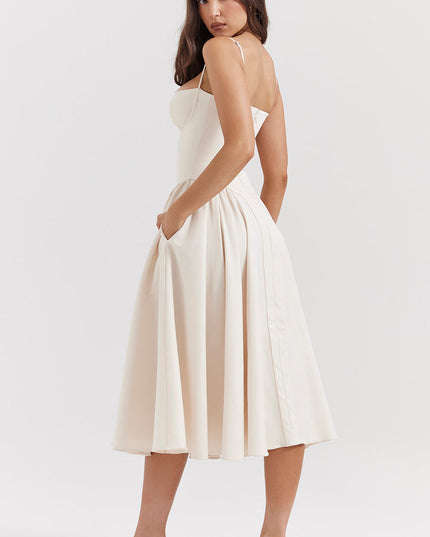 Ivory corset midi dress side view showing fitted bodice, thin straps, and flowing pleated midi skirt