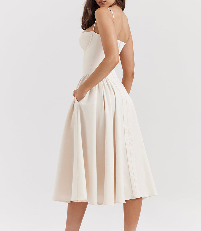 Ivory corset midi dress side view showing fitted bodice, thin straps, and flowing pleated midi skirt