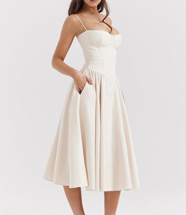 Ivory corset midi dress three-quarter view with hand in pocket, structured bodice and flared midi skirt