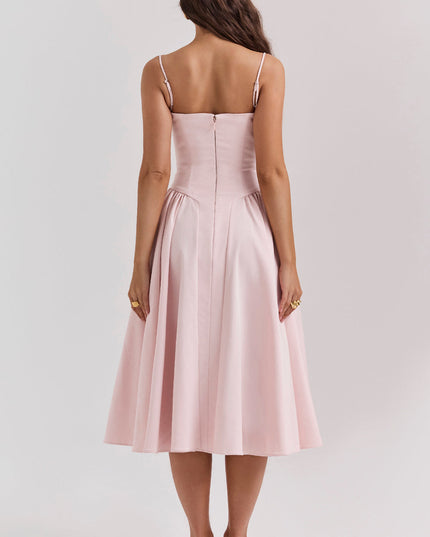 Back view of blush pink corset midi dress with thin straps, fitted bodice seams, and center zipper