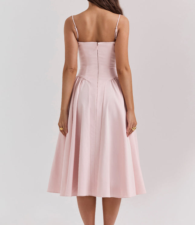 Back view of blush pink corset midi dress with thin straps, fitted bodice seams, and center zipper