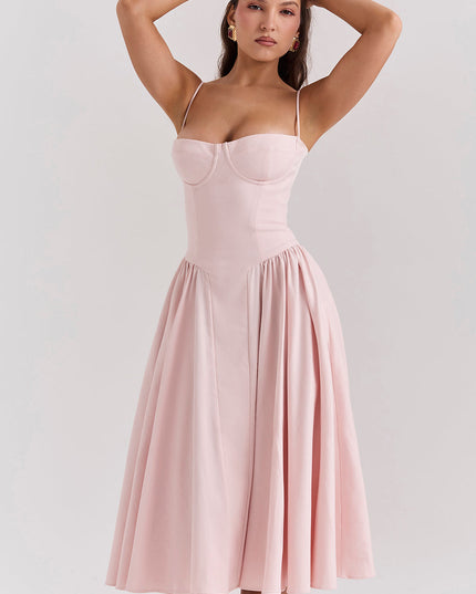 Blush pink corset midi dress front view with arms raised, highlighting structured bodice and full skirt
