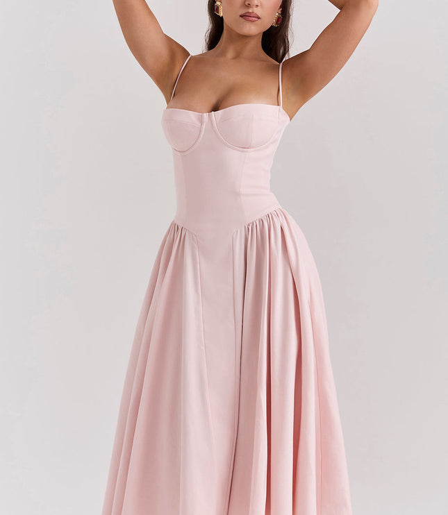 Blush pink corset midi dress front view with arms raised, highlighting structured bodice and full skirt