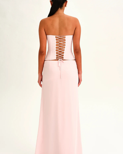 Blush pink strapless corset maxi dress back view with lace-up corset panel and floor length skirt