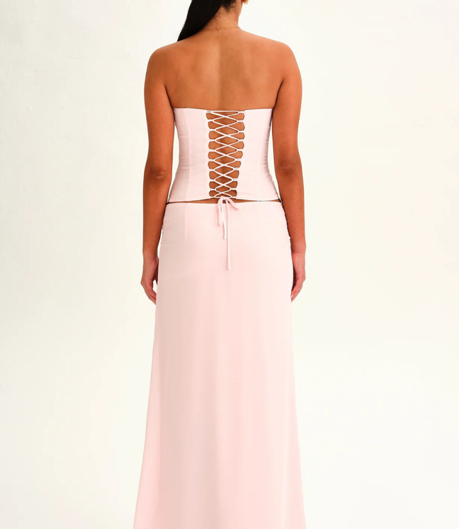 Blush pink strapless corset maxi dress back view with lace-up corset panel and floor length skirt