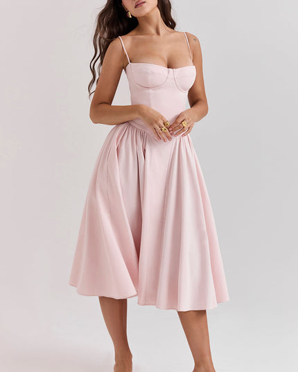 Blush pink corset midi dress front pose highlighting structured bustier bodice and gathered skirt