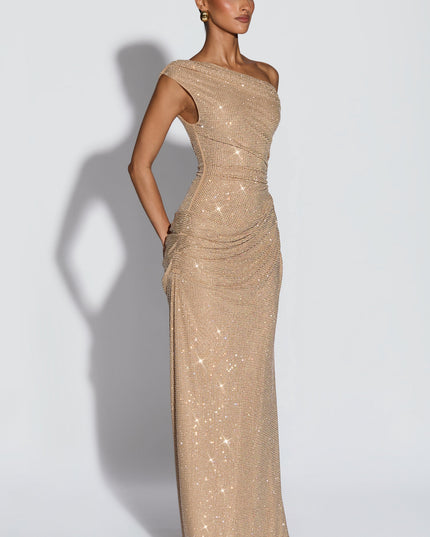 Side view of champagne off-shoulder sequin maxi dress with smooth skirt and ruched hip detail