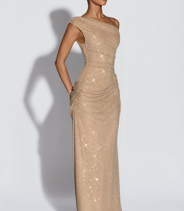 Side view of champagne off-shoulder sequin maxi dress with smooth skirt and ruched hip detail