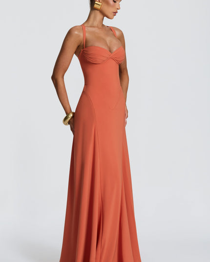 Side view of coral pleated maxi dress with sweetheart neckline, fitted waist and flowy skirt