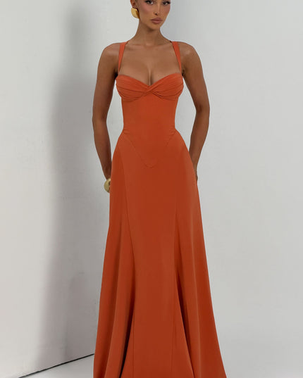 Full length coral pleated maxi dress with twisted bust and wide straps, studio front view