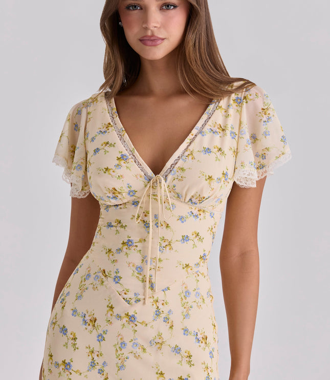 Closeup of cream floral lace V-neck maxi dress showing tie front, lace trim, and flutter sleeves