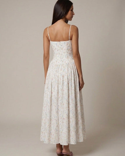 Back view of white floral corset midi dress with thin straps and gathered midi skirt
