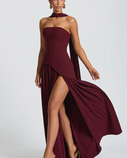 Burgundy halter maxi dress with high slit, draped bodice, and sweeping skirt movement