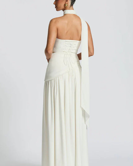 Pink halter maxi dress with strapless bodice, pleated skirt, and sheer draped scarf