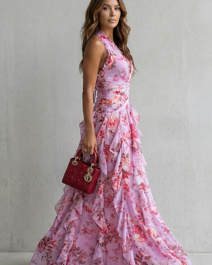 Side view of lilac floral halter maxi dress with fitted waist and cascading ruffle layers on skirt