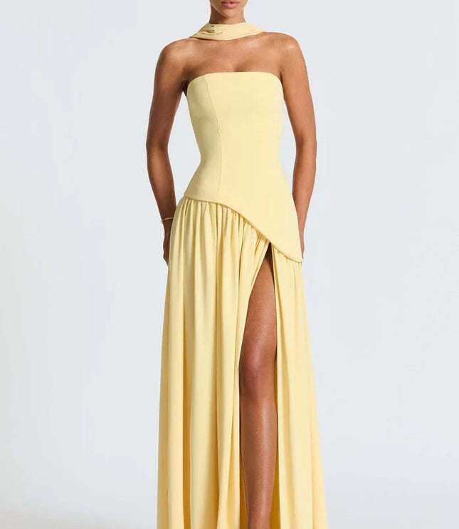 Pale yellow halter maxi dress showing the strapless bodice and high slit from the front