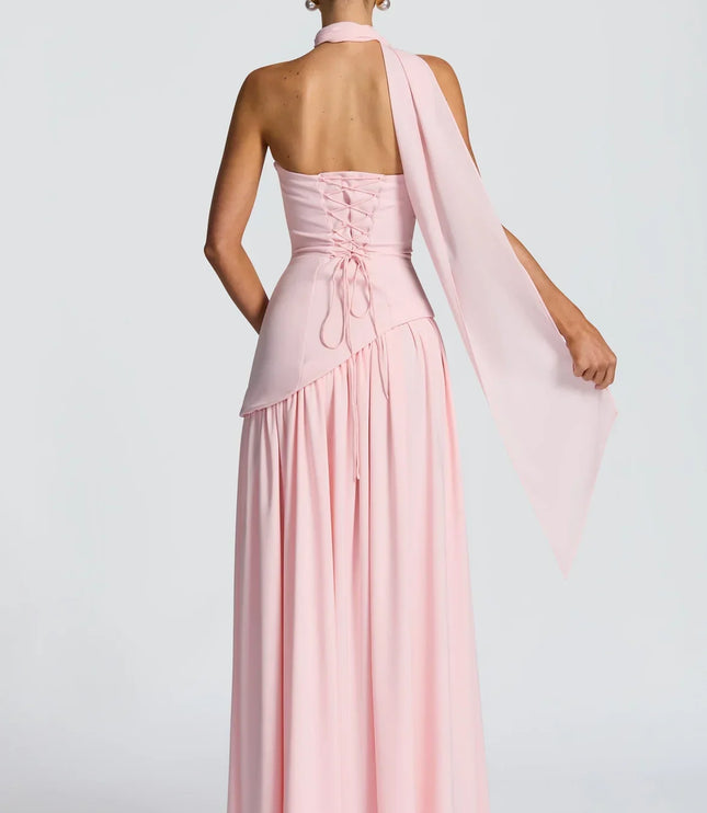 Back view of pink halter maxi dress with lace-up back, scarf tie, and long skirt