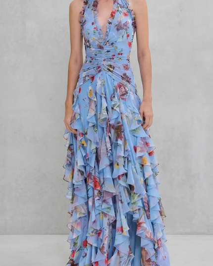 Light blue floral halter maxi dress with plunging v-neck, ruched waist, and dramatic ruffle skirt front