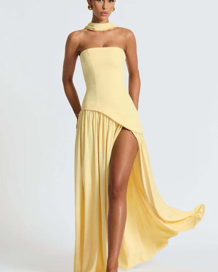 Pale yellow halter maxi dress with dramatic side drape, thigh slit, and strapless bodice side view