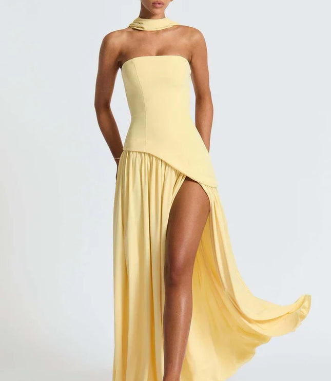 Pale yellow halter maxi dress with dramatic side drape, thigh slit, and strapless bodice side view