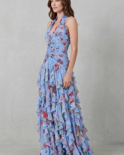 Side view of light blue floral halter maxi dress with fitted bodice and cascading ruffle skirt layers