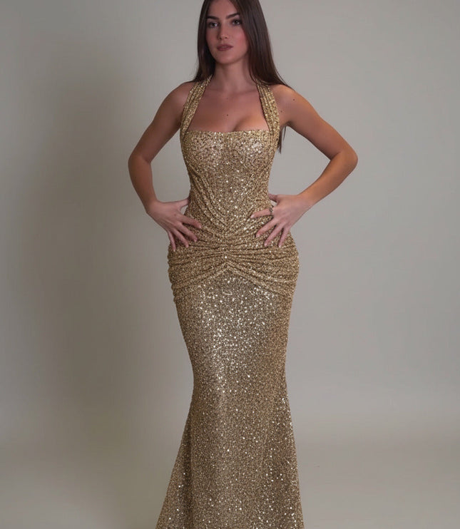 Gold sequin halter maxi dress with ruched waist and fitted mermaid skirt, front view
