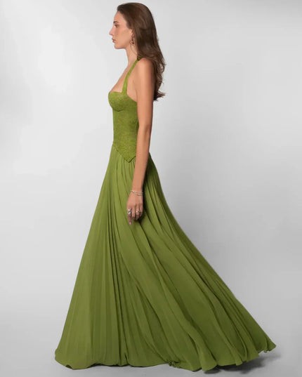 Side profile olive green halter lace maxi dress with structured bodice and sweeping pleated hem