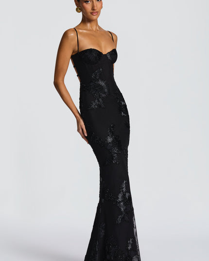 Black floral lace maxi dress with thin straps and bustier bodice, angled side view