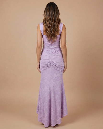 Back view of lavender lace midi dress with wide straps, fitted bodice, and ruched skirt