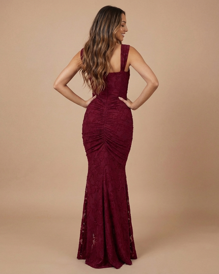 Back view of burgundy lace midi dress with wide straps, ruched center seam, and flared hem