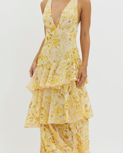 Closeup of yellow floral maxi dress bodice with deep v-neckline and ruffled tier detail