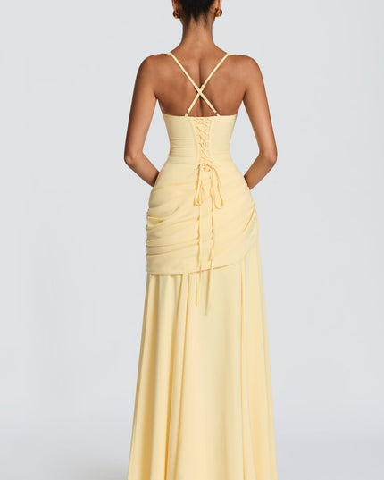 Back view of pale yellow satin maxi dress with crisscross straps and lace-up detail