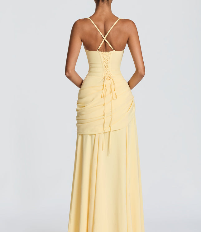 Back view of pale yellow satin maxi dress with crisscross straps and lace-up detail