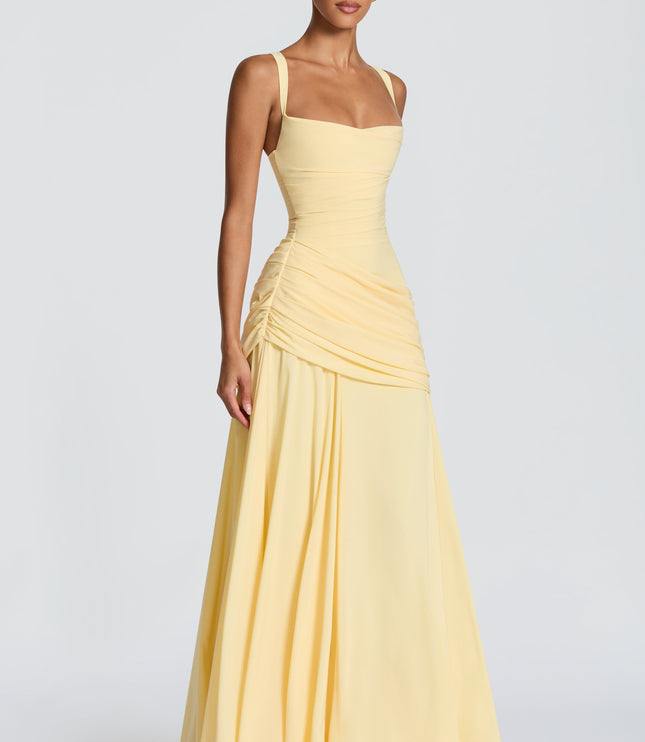 Pale yellow square neck satin maxi dress with fitted bodice and soft draped skirt, angled front view