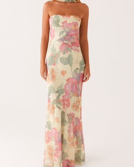 Front view of women's strapless floral maxi dress in a light yellow hue with vibrant pink and green floral patterns.
