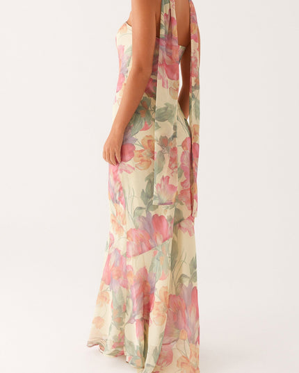 Three-quarter back view of the women's floral strapless maxi dress, showing the flowing scarf and delicate floral print.