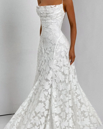 Side profile of a women's white floral jacquard maxi dress, highlighting the textured fabric and elegant fit.