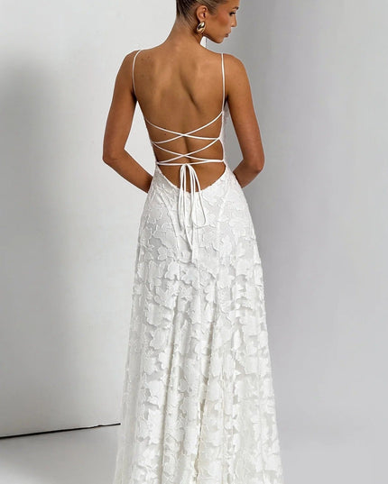 Back view of a women's white floral jacquard maxi dress, displaying the intricate lace-up back and flowing skirt.