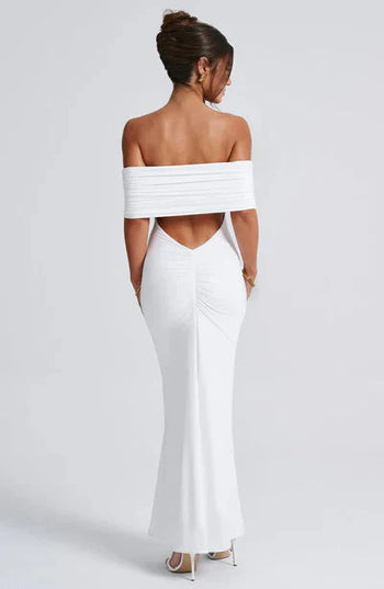 Back view of a white off-shoulder maxi dress, with a stylish ruched back and a graceful V-neckline.