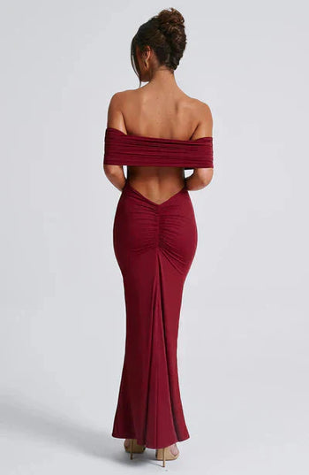 Rear view of a rich burgundy off-shoulder maxi dress, featuring a deep V-back and ruched detailing.