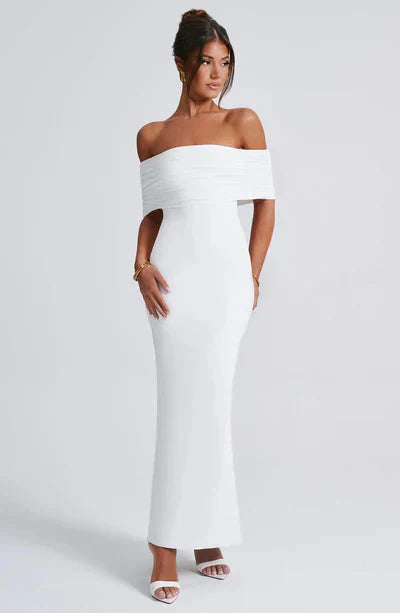 Front view of a white off-shoulder maxi dress, showing the elegant ruched bodice and sleek, tailored fit.