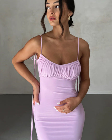 Close-up front view of a light purple pleated plunge neck maxi dress, highlighting the ruched top and fabric texture