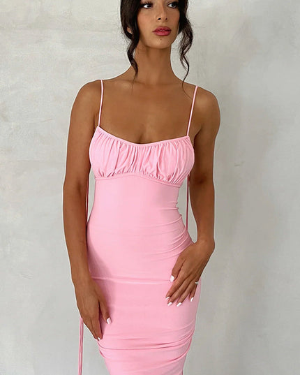 Close-up of a pink pleated plunge neck maxi dress, featuring the ruched bust and side details