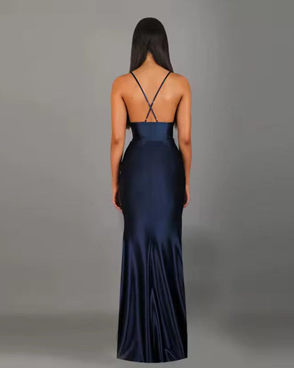 Back view of a navy blue formal backless V-neck maxi dress with delicate criss-cross straps.