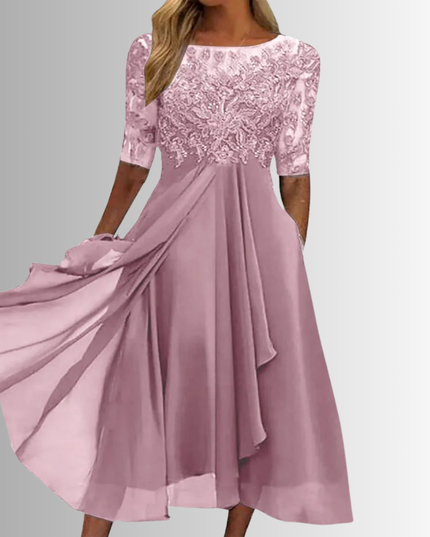 Elegant pink boat neck midi dress for women, featuring a delicate lace top, sheer three-quarter sleeves, and a layered chiffon skirt with side pockets, ideal for a wedding.