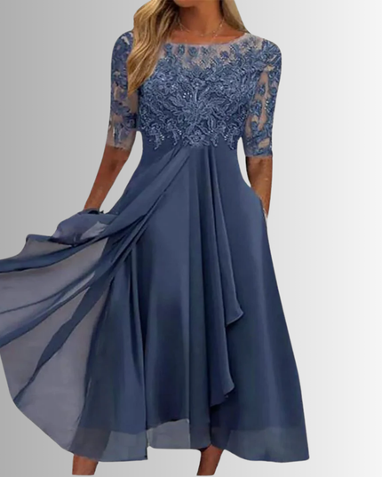 Women's slate blue boat neck midi dress with intricate lace bodice, sheer elbow-length sleeves, and flowing chiffon skirt with pockets, for wedding guests.